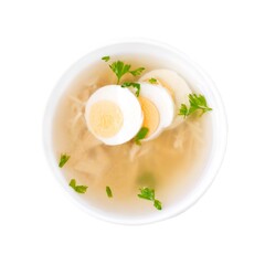 Chicken soup with vermicelli and boiled eggs in the white bowl isolated on white. Nutritious hot meal