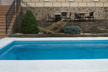 Pool with blue water. Swimming pool in the courtyard of the hotel. Landscaping