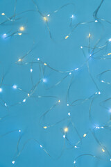 Texture of New Year or Christmas garland on a blue background. Abstract painting