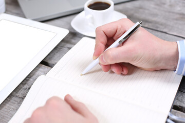 businessman record data on to schedule a meeting or event