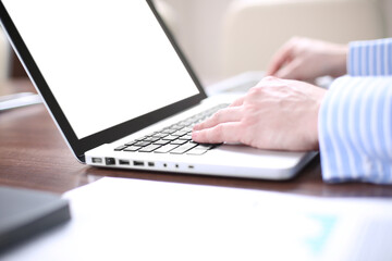 Businessman working in modern cretive studio. Using generic design laptop.