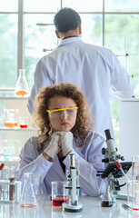 Young scientists or researchers doing chemical research in laboratory. Scientist discovering new drug or vaccine.