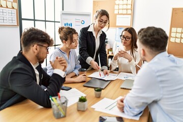 Group of young business workers listening boss speech during meeting at the office.