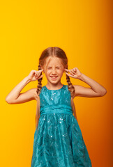 Portrait of a little girl screaming with an open mouth and a crazy expression. Surprised or shocked faces