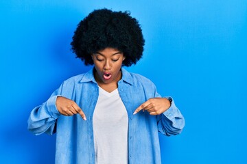 Fototapeta na wymiar Young african american woman wearing casual clothes pointing down with fingers showing advertisement, surprised face and open mouth