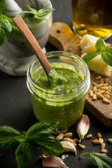 traditional italian pesto with ingredients over black background - 452294985