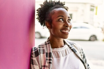 Young african american girl smiling happy standing at the city.