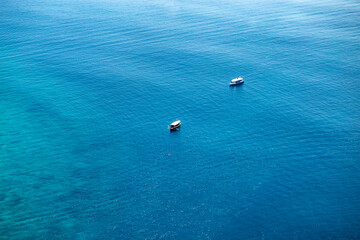 Aerial view luxury motor boat. Airplane  view of a boat sailing. Top view of a white boat sailing to the blue sea.