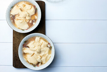 Top View Wedang Tahu or Kembang Tahu or Tahwa. Soybean Pudding Dessert in Ginger and Palm Sugar Syrup. Indonesia Traditional Drink with Peranakan Style Influences. Copy Space for Text