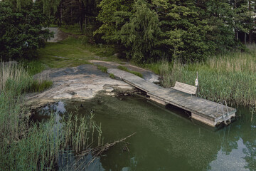 Aerial top view of old wooden pier, sea coast