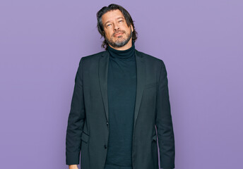 Middle age handsome man wearing business clothes relaxed with serious expression on face. simple and natural looking at the camera.