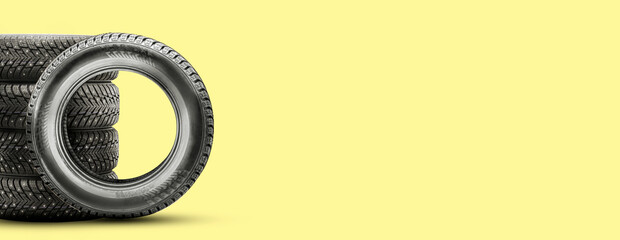 winter studded tires, isolate on a yellow background copy space. auto parts and tire changes