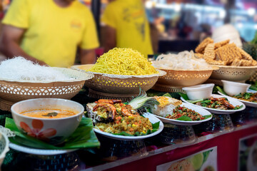thai food at the market in Phuket. noodles, tom yam soup, salads and traditional street food of Thailand on display