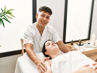 Fototapeta premium Young woman reciving relaxing massage at beauty center.