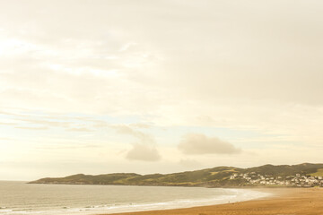 Beach view across the sand with sea shore and seaside town