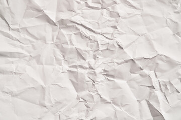 Fototapeta premium White crumpled paper texture with wrinkles. Damaged and torn sheet