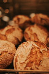 Artisan bread piled up on a bakery