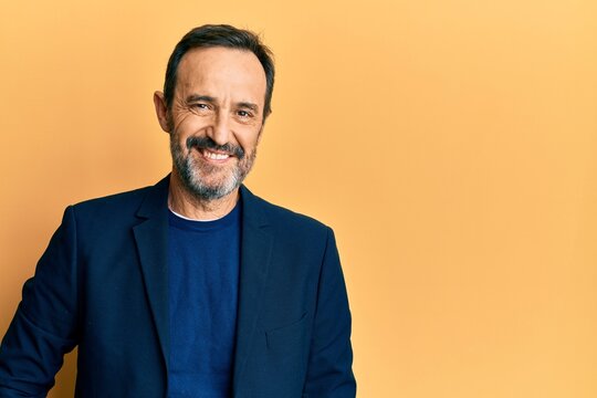 Middle age hispanic man wearing business clothes with a happy and cool smile on face. lucky person.