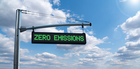 Road information board with text ZERO EMISSIONS on a background of blue sky. Clean mobility concept