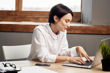 Business woman at work table in front of laptop professional office