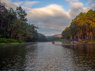 The beautiful sunshine with the pine and the raft on the reservoir of the higher mountain, Pang Oung, which dubbed is as Switzerland, Mae hong son, Thailand.