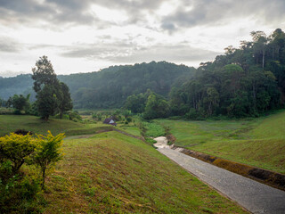Fototapeta na wymiar The beautiful green grass and the small stream Pang Oung, which dubbed is as Switzerland, Mae hong son, Thailand.