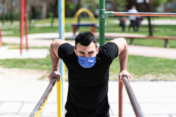 Man Exercising On Parallel Bars Outdoors