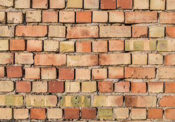 Fototapeta premium Brickwork during the construction of a residential building as a background.