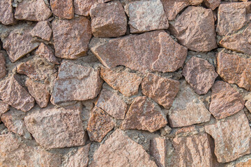 A wall of granite stones as a background.