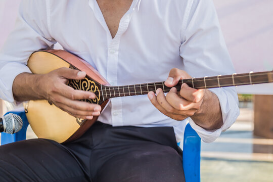 Musical instrument dombra in the hands of a musician