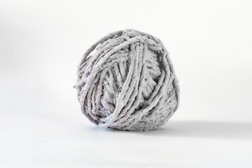 Fototapeta na wymiar Side view of a grey thread ball of recycled textiles