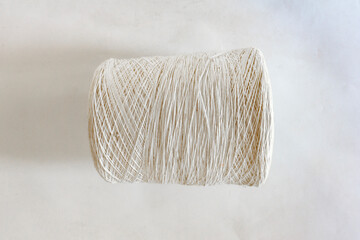 Top view of a white thread roll on white background