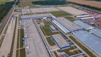 Aerial view of modern factory. Industrial territory and many cars nearby from above. Industrial concept.