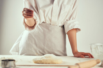 Obraz na płótnie Canvas chef kneading dough on the table kitchen baking professional
