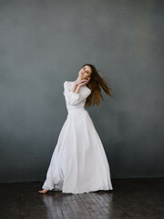 Fototapeta na wymiar pretty woman in white dress posing full length Studio Model