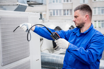 the technician uses a digital camera to check the clogging of the heat exchanger