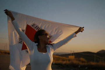 Black girl with Minas Gerais state flag