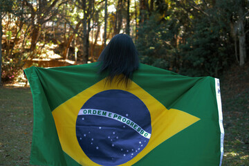 Patriot girl hugged with Brazilian flag