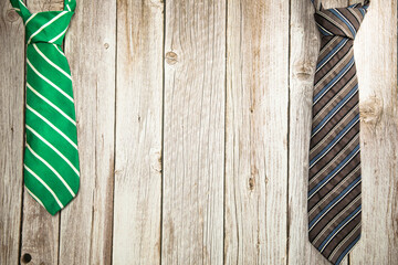 Colorful green and brown necktie on wooden background texture, National men's Day, Father Day design with copy space
