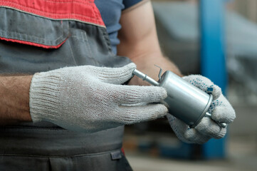 Spare parts for the car.A new fuel filter is in the hands of an auto mechanic.Maintenance and...