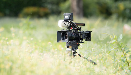a movie camera or documentaries equipped with monitors for cinematographers. and a boom mic for...