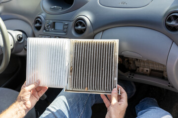 Replacing the dirty cabin pollen air filter for a car - obrazy, fototapety, plakaty