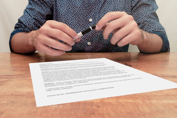 Person with both hands on the pen waiting for you to sign the sales contract. Notaries