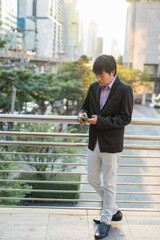 Korean Businessman ceo using smartphone in city