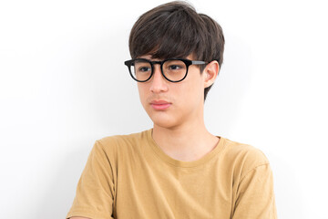 Fototapeta premium Handsome teen boy with glasses in casual brown t-shirt isolated on white background.