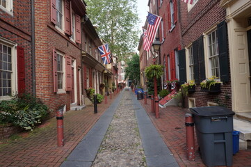 Historic Colonial Brick Row Hmes with Window Boxes Cobblestone Walkway on Summer Day