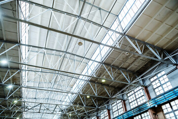 A roof made of glass and metal in an industrial plant. Inside view