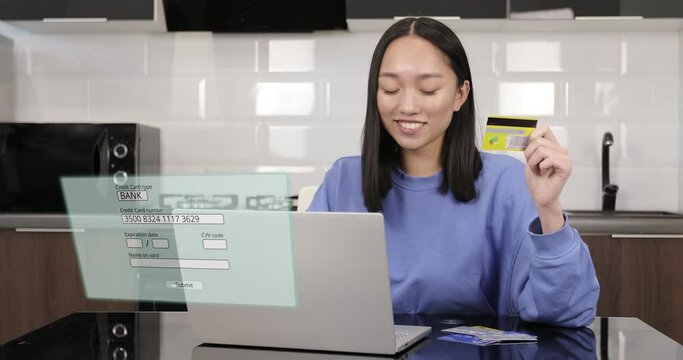 Young Asian female hands of cardholder holding credit card making e bank online payment.Virtual screen with payment. Asian Woman consumer paying for purchase in web store using smartphone technology. 