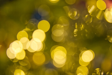 Obraz premium blurred christmas lights abstract background on dark backdrop. Yellow Circular reflections of Christmas lights.