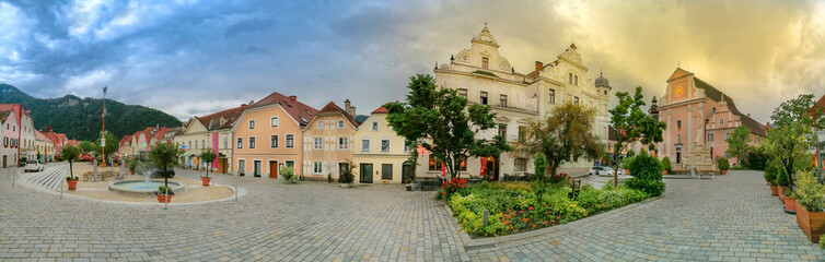 Naklejka premium The main square with old buildings and Parish Church in the charming little town of Frohnleiten in the district of Graz-Umgebung, Styria region, Austria